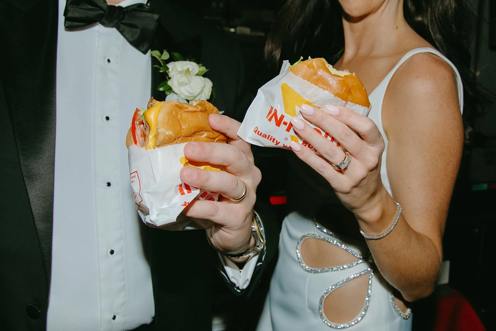 A bride and groom eating in-and-out at their Palm Springs wedding reception