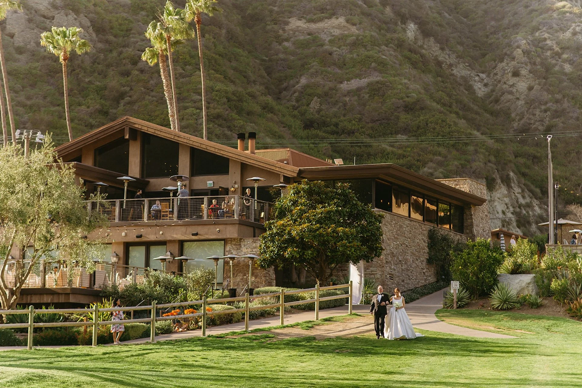 Exterior view of the reception space and clubhouse nestled into the canyon during The Ranch at Laguna Beach wedding day.