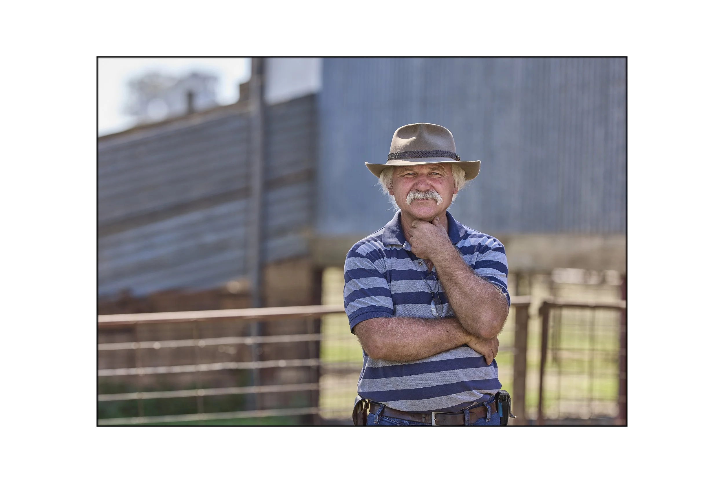 This image shows a goat Farmer assessing the goats on his property in Victoria Australia photographed by Steen Vestergaard.  landscape photographer, landscape photography, food production, primary producer, farm photography, farmer photographer, prim