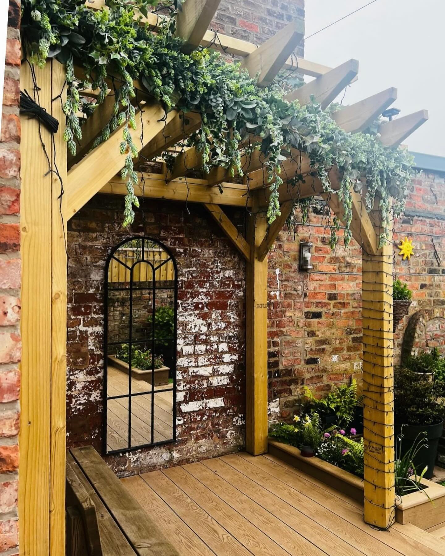 Garlands for outside. So delighted with these pics from Sarah @sarah.adnett of her perfect garden and faux evergreen garlands that I made for her pergola. It looks fab xx #fauxgarland #faux flowers #artificial flowers