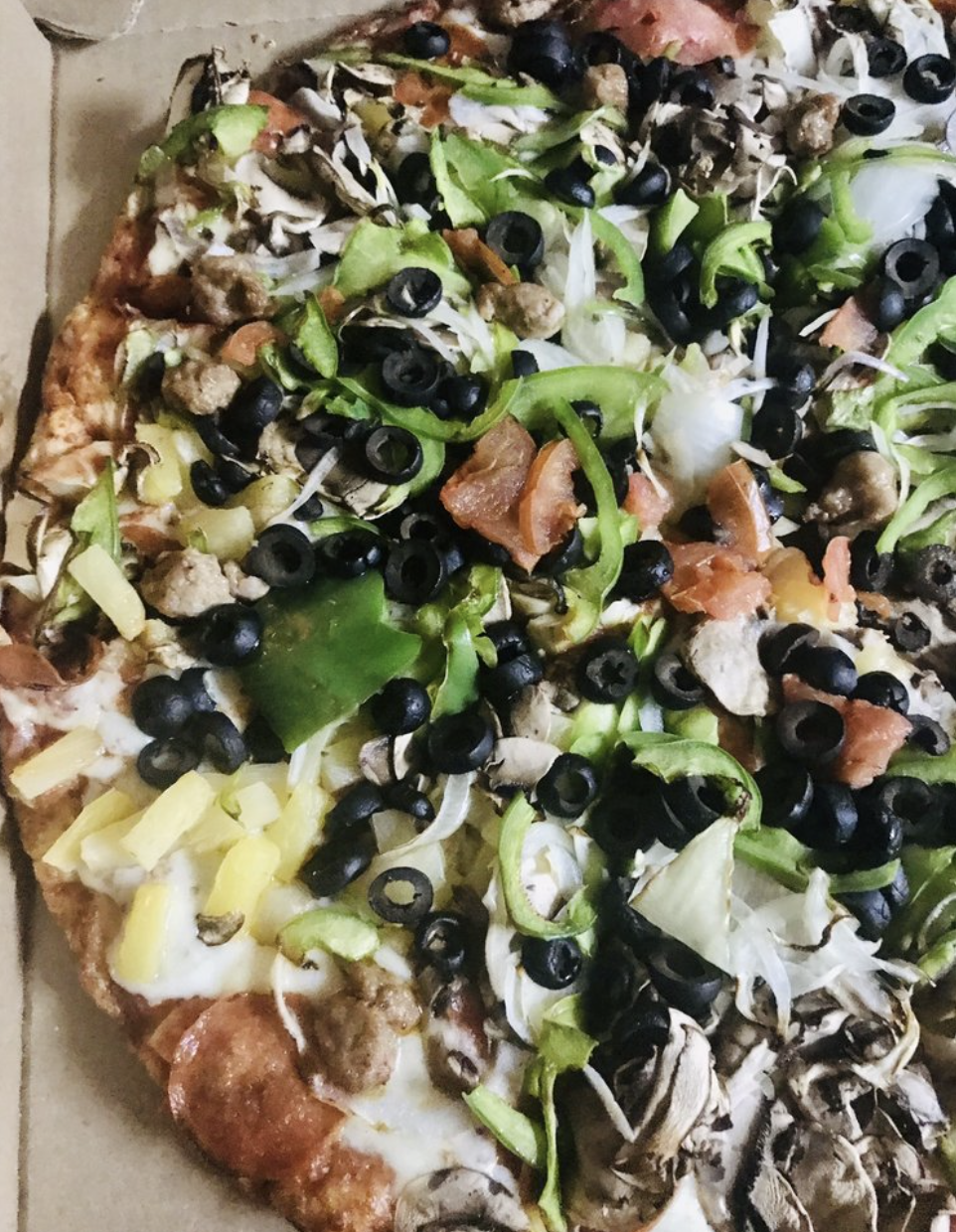 Photo of pizza with olives and green bell peppers