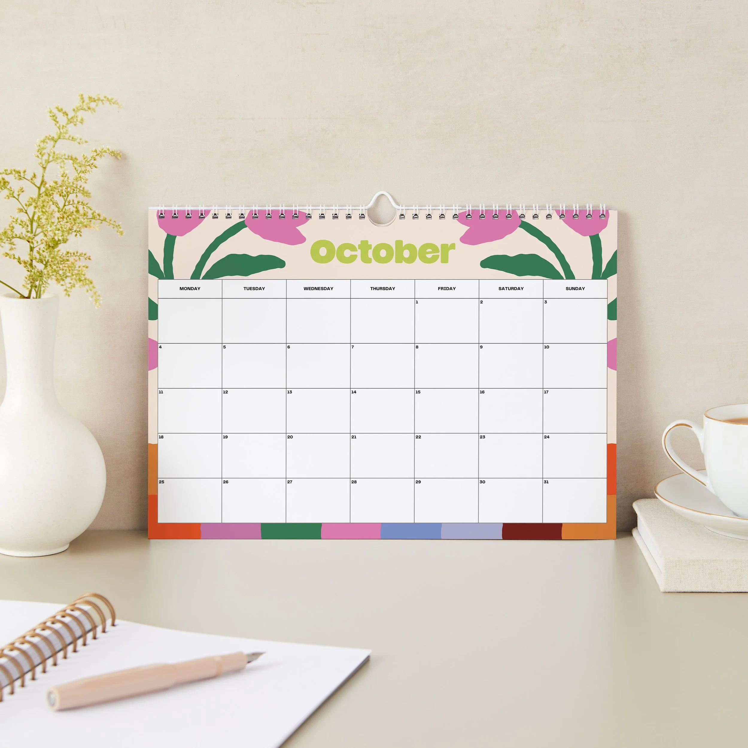 October 2027 page of the Sofe Store wall calendar with pink tulips, a lime green “October” heading and a rainbow striped border
