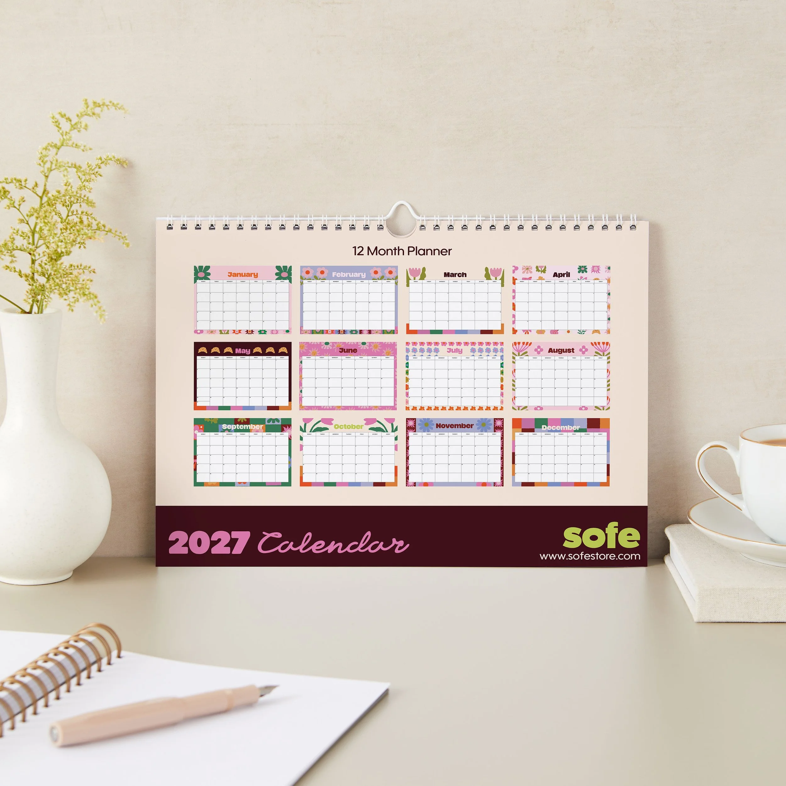 Back page of the Sofe Store 2027 calendar showing a mini preview of all twelve floral-themed months above a burgundy band with the Sofe Store logo and sofestore.com