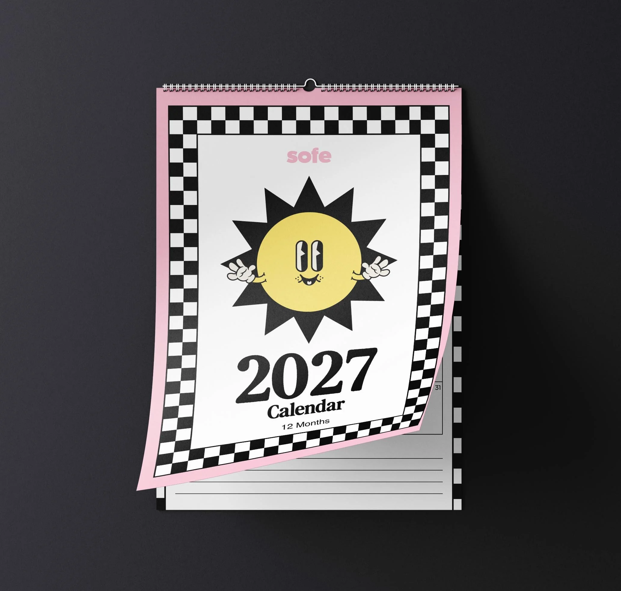 Sofe Store 2027 retro wall calendar on a dark background with the checkerboard sun cover page curling up to reveal the monthly planner page and lined Notes section beneath