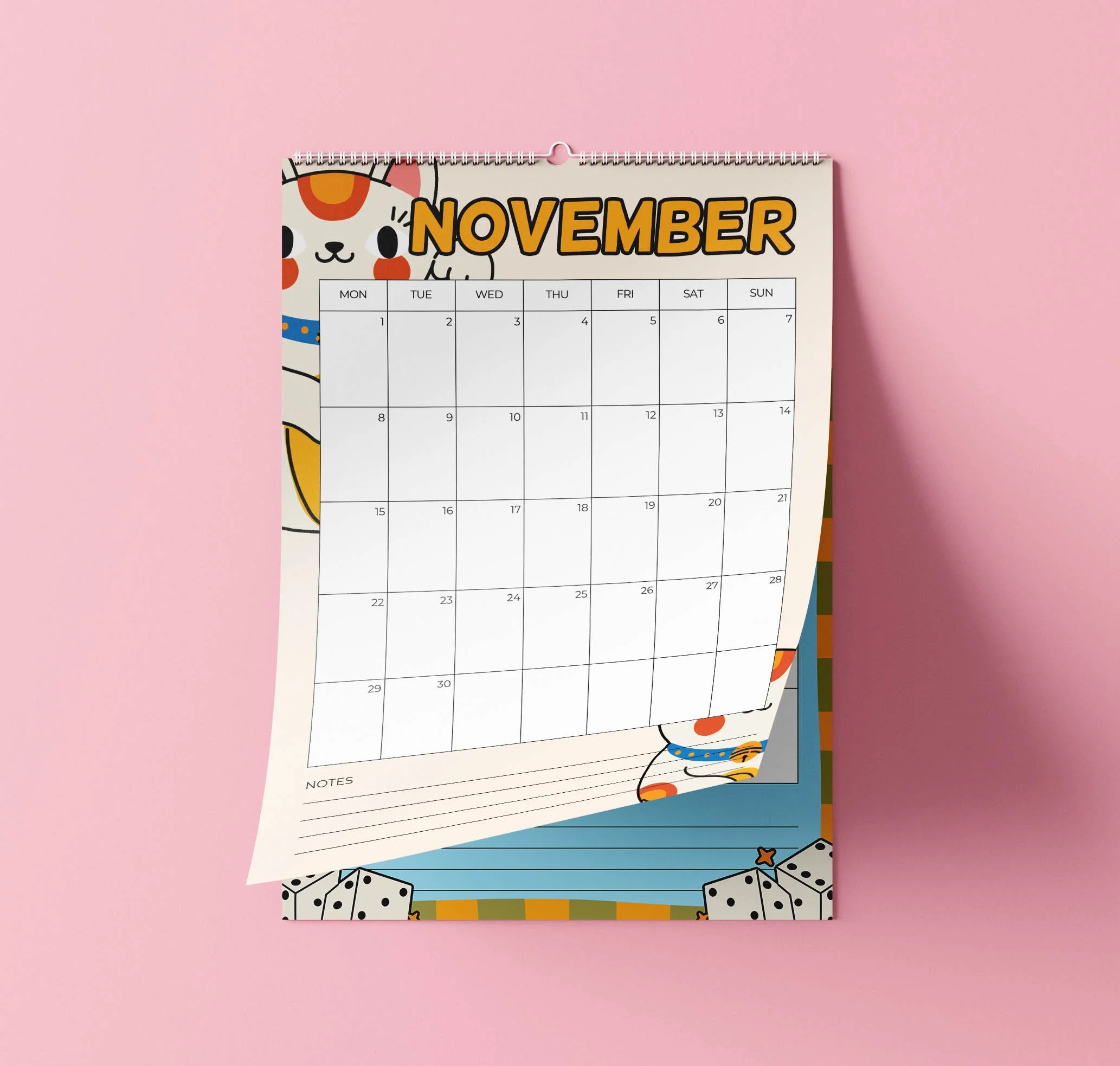 November 2027 page of the Sofe Store wall calendar curling up to reveal the page beneath, with an orange “November” heading, a lucky cat peeking out, a date grid and lined Notes section