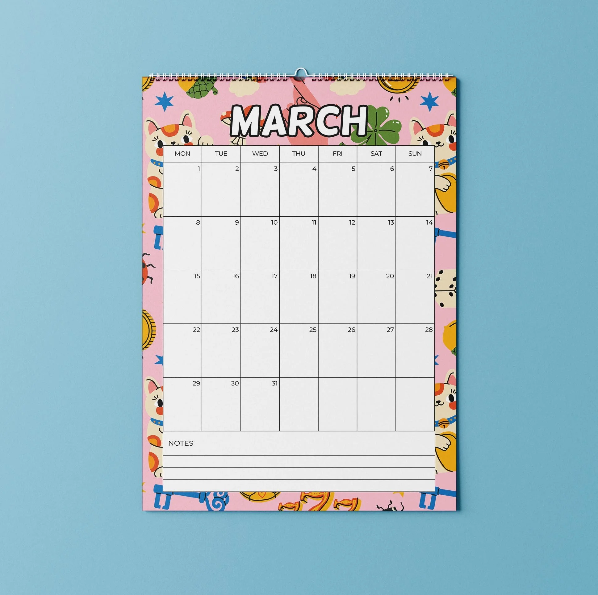 March 2027 page of the Sofe Store wall calendar with a pink background covered in lucky cats, four-leaf clovers and coins, a Monday-to-Sunday date grid and a Notes section