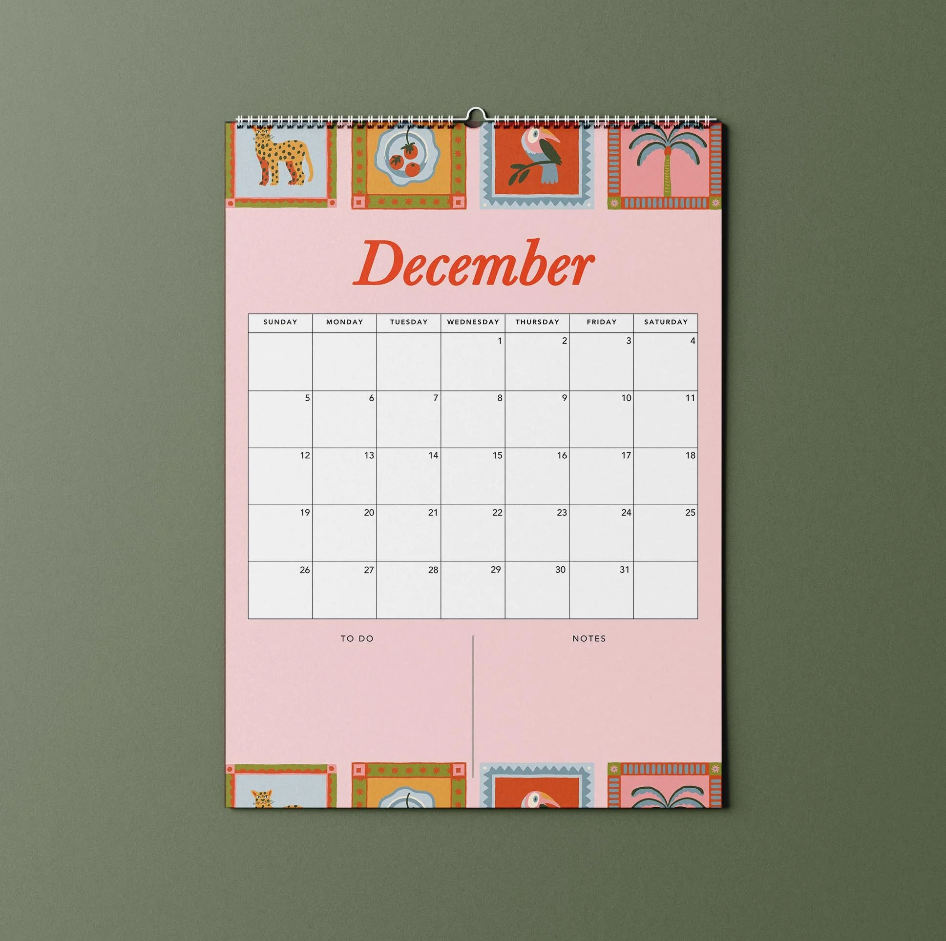 December 2027 page of the Sofe Store wall calendar with a pink background, stamp-style illustrations of a leopard, toucan, palm tree and fruit plate, and To Do and Notes sections