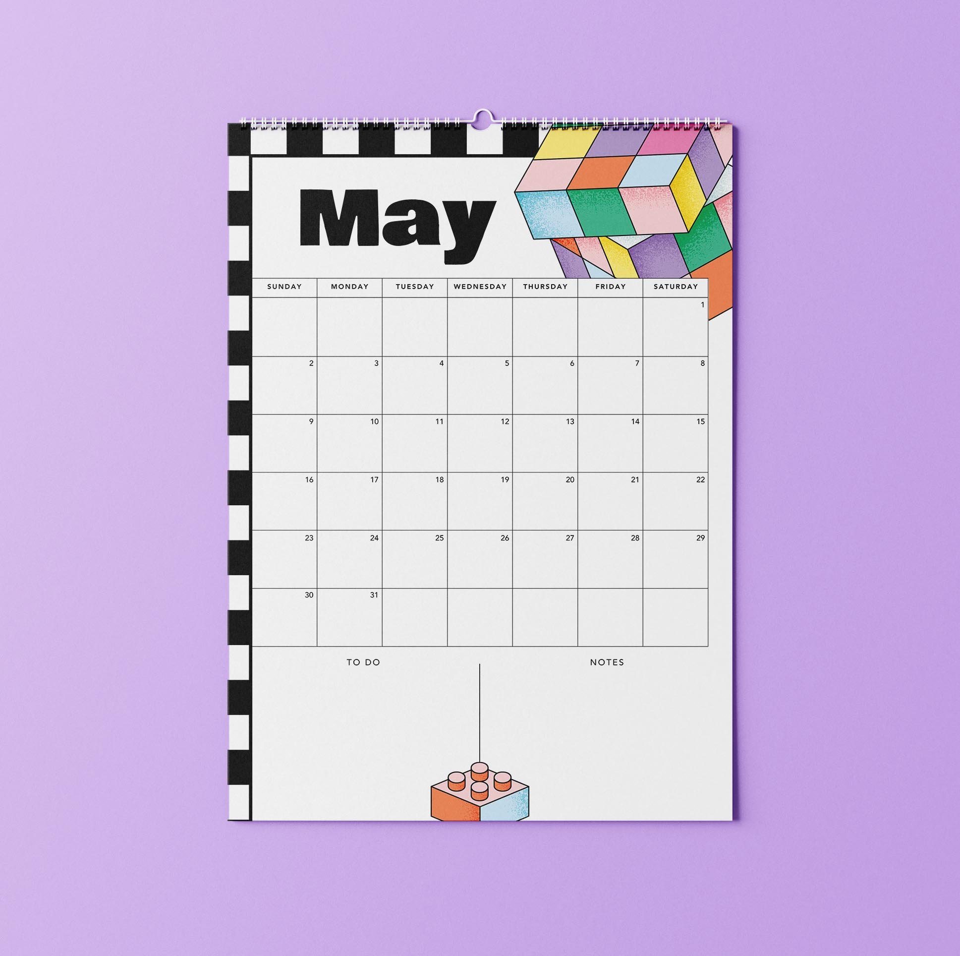 May 2027 page of the Sofe Store wall calendar with a bold black “May” heading, a checkerboard edge, a pastel puzzle cube, a Sunday-to-Saturday date grid and To Do and Notes sections