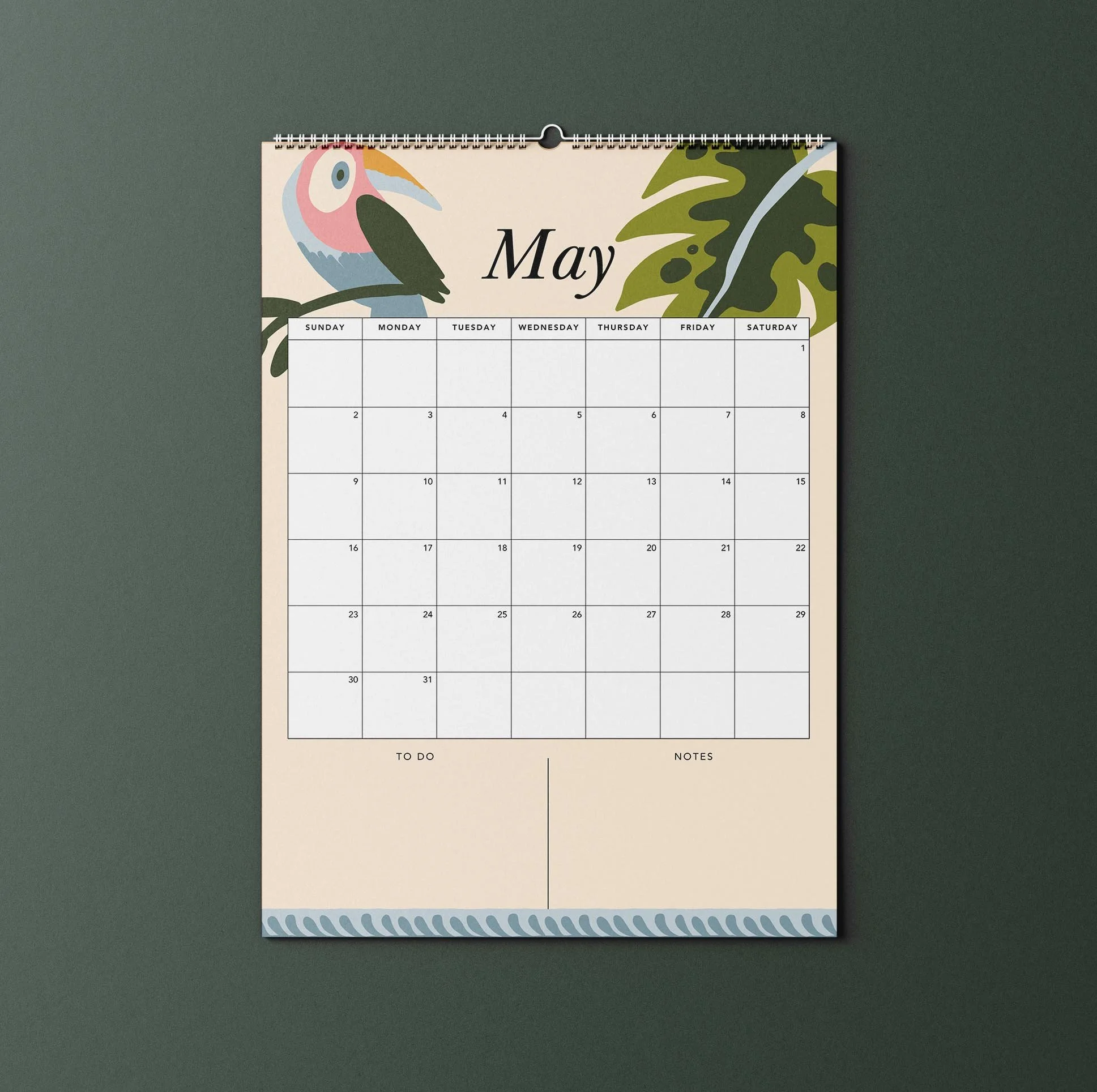 May 2027 page of the Sofe Store wall calendar with an illustrated toucan and monstera leaf, a Sunday-to-Saturday date grid, and To Do and Notes sections