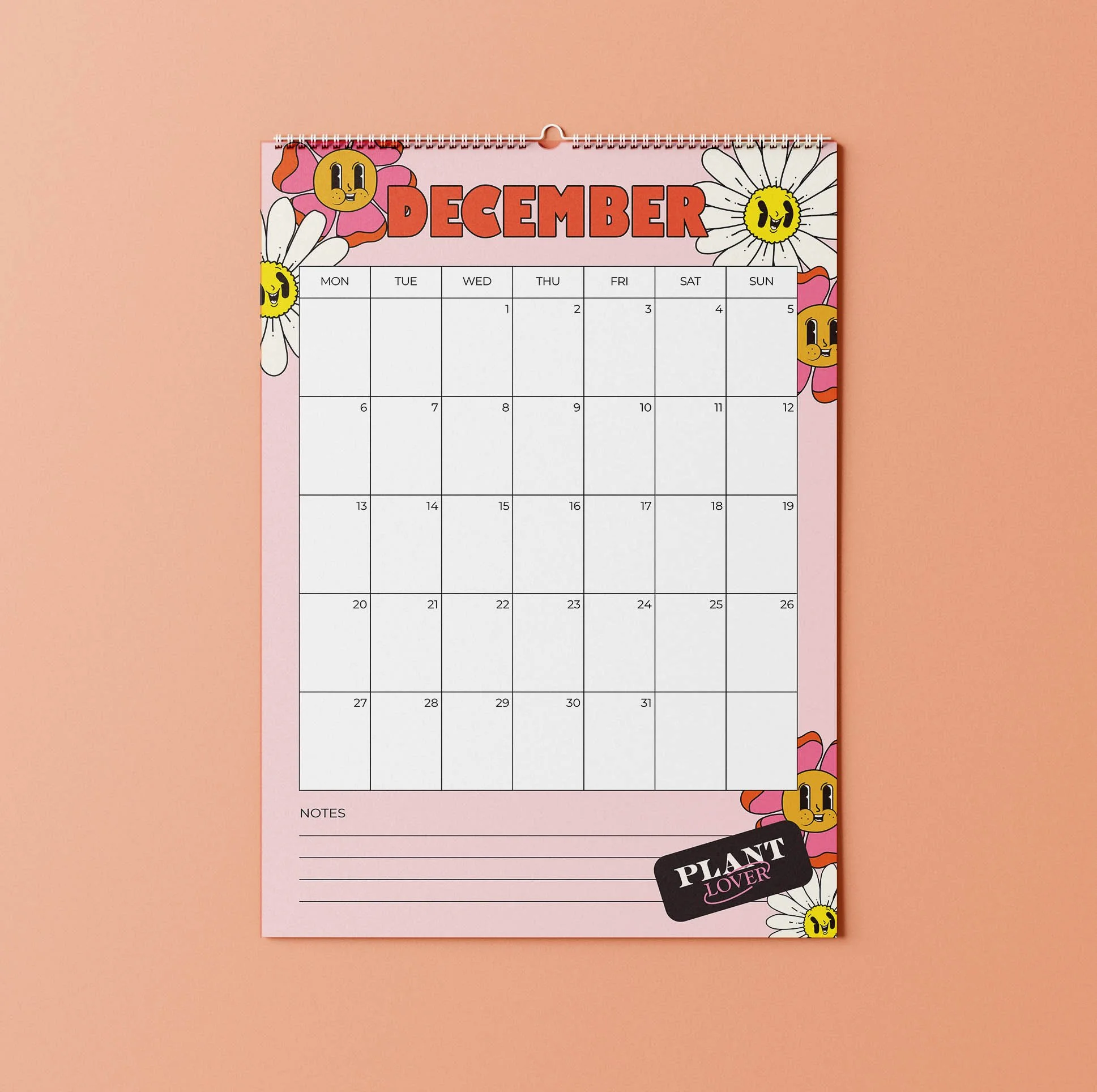 December 2027 page of the Sofe Store wall calendar with a pink background, smiling retro daisies, a red “December” heading, a Monday-to-Sunday date grid and a lined Notes section