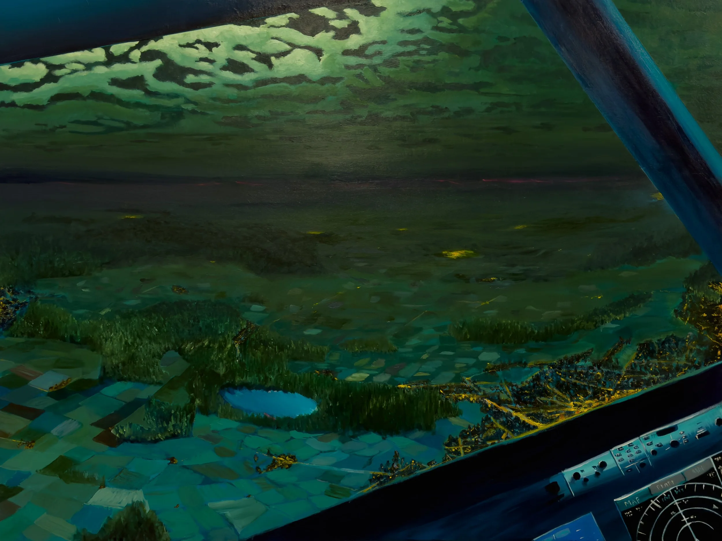 View from an airplane cockpit showing a landscape with fields, trees, a river, and a lake beneath a cloudy sky.