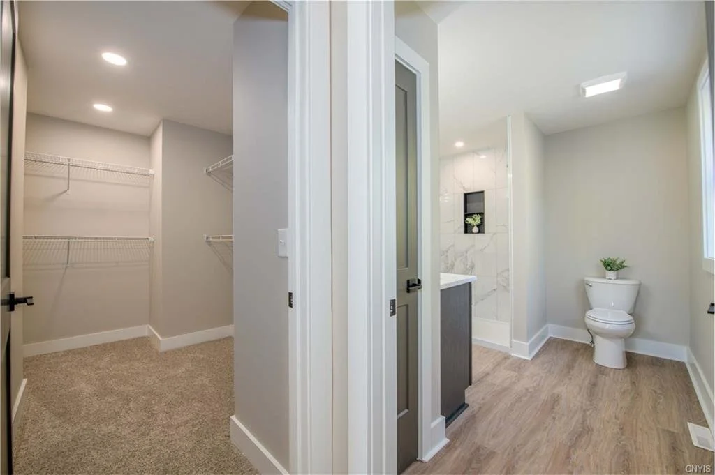Walk in closet and primary bathroom