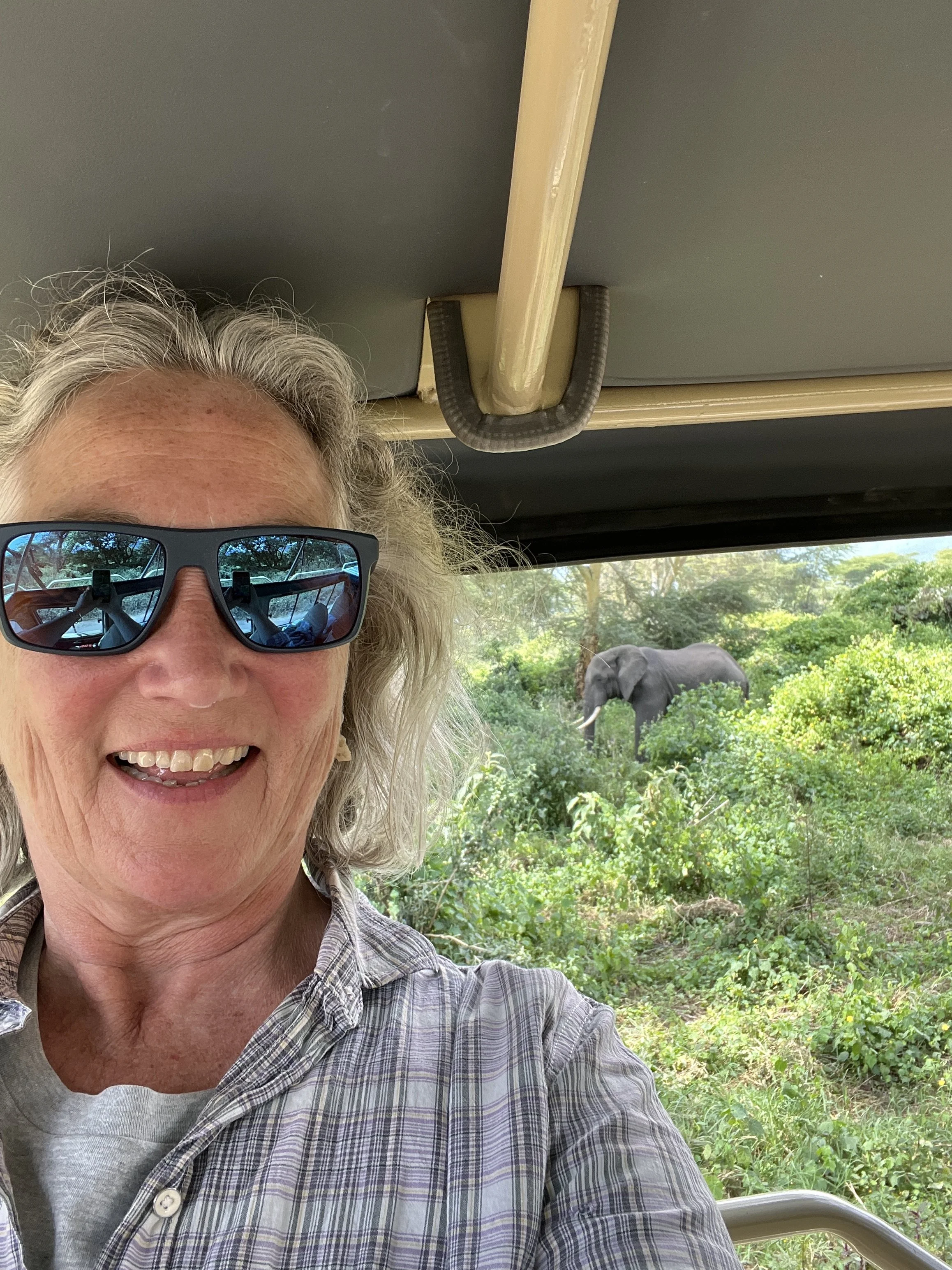 Lucie with an elephant in the background in the Ngorongoro conservation area