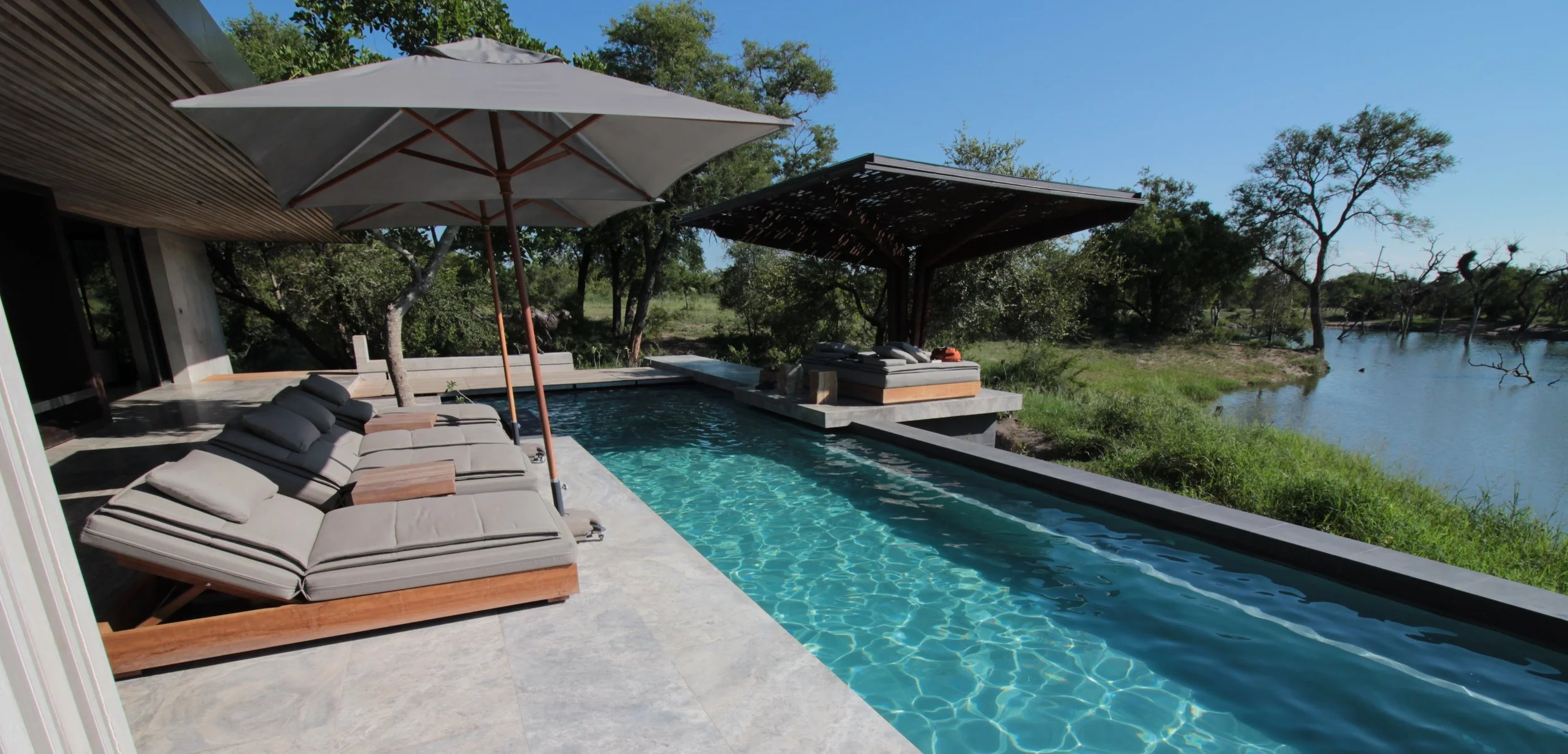 a sparkling blue pool overlooking a waterhole