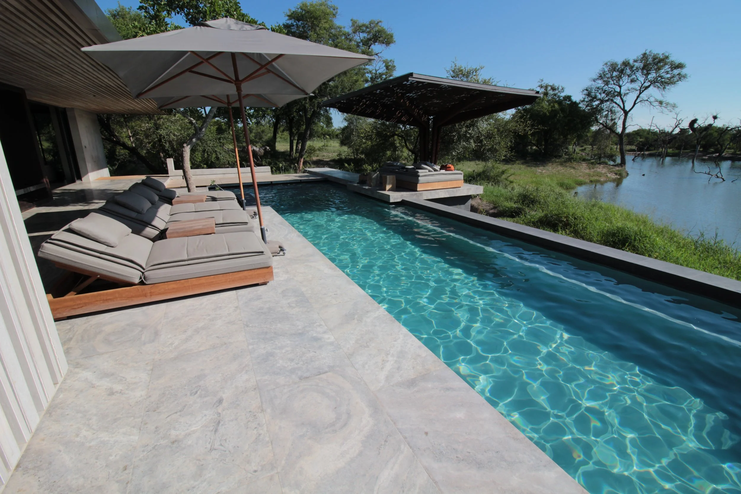 Sunloungers by a pool overlooking a waterhole in South Africa