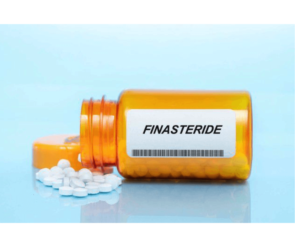 An orange prescription pill bottle labeled 'FINASTERIDE' with white tablets spilled out onto a light blue surface.