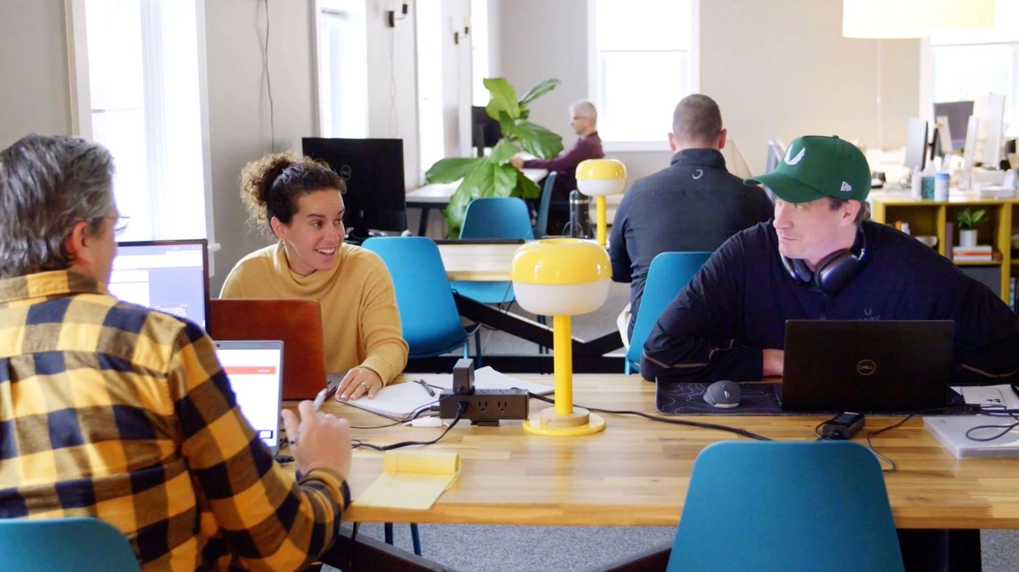 Members working side by side at a shared table at R5 Co-Lab