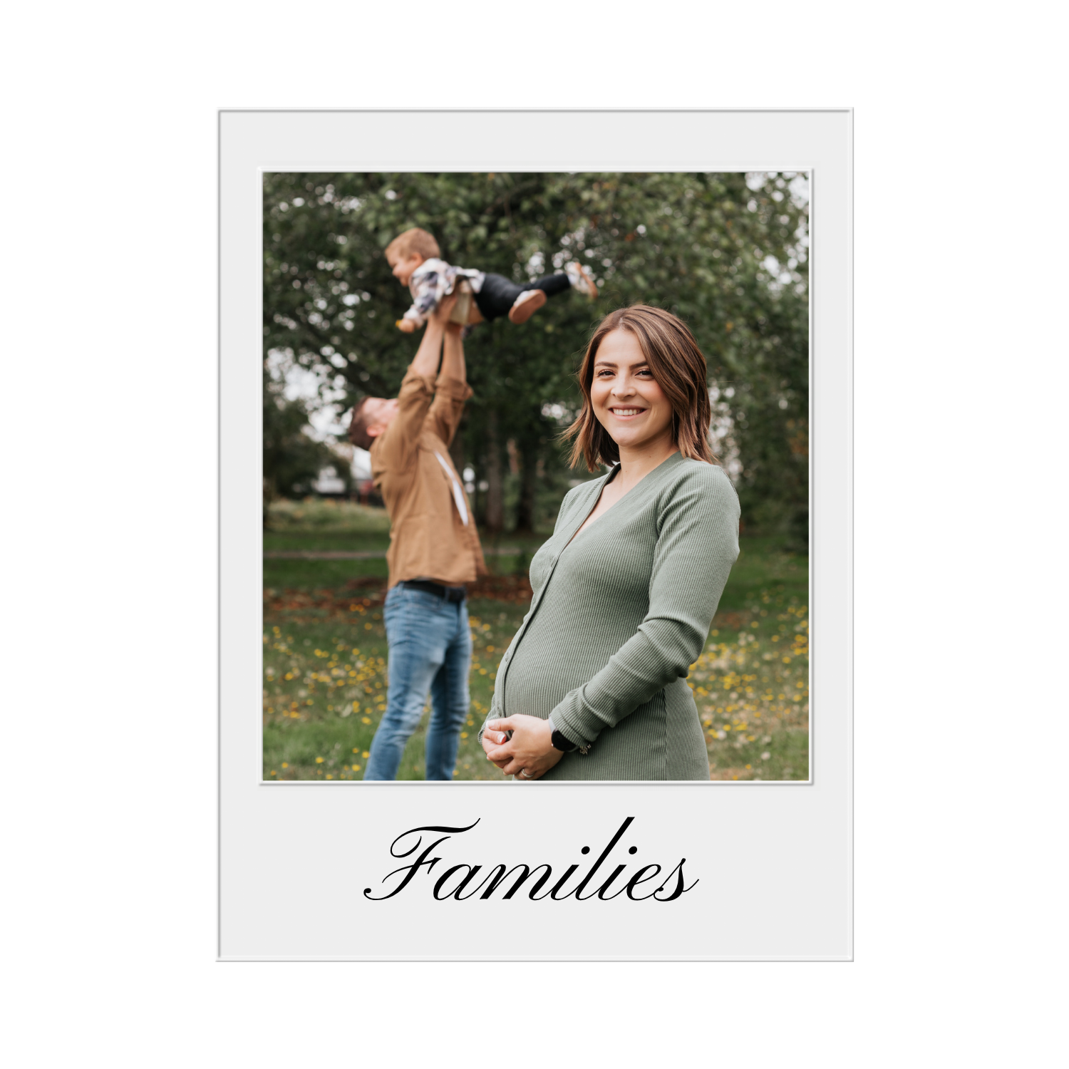 A smiling pregnant woman in a green dress standing outdoors in a park, with a man in the background lifting a young child into the air, surrounded by trees and fallen leaves. The word 'Families' is written at the bottom.