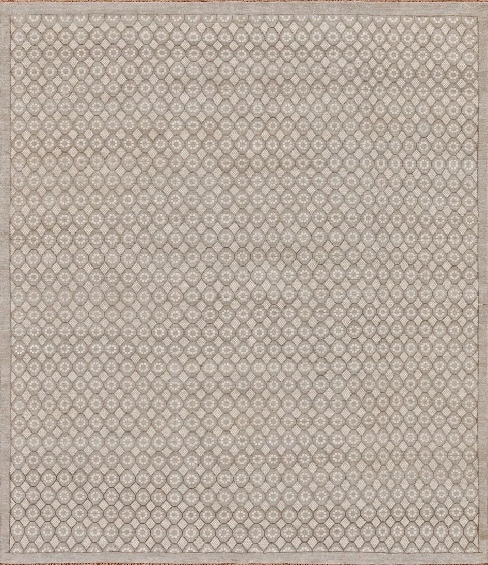 A beige and white geometric patterned rug with a hexagon border.