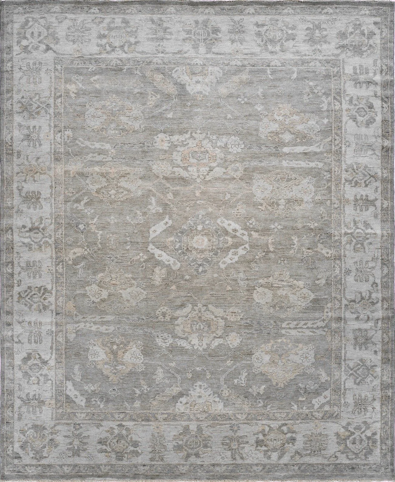 Light-colored vintage-style area rug with intricate floral and geometric patterns in shades of beige, gray, and cream.