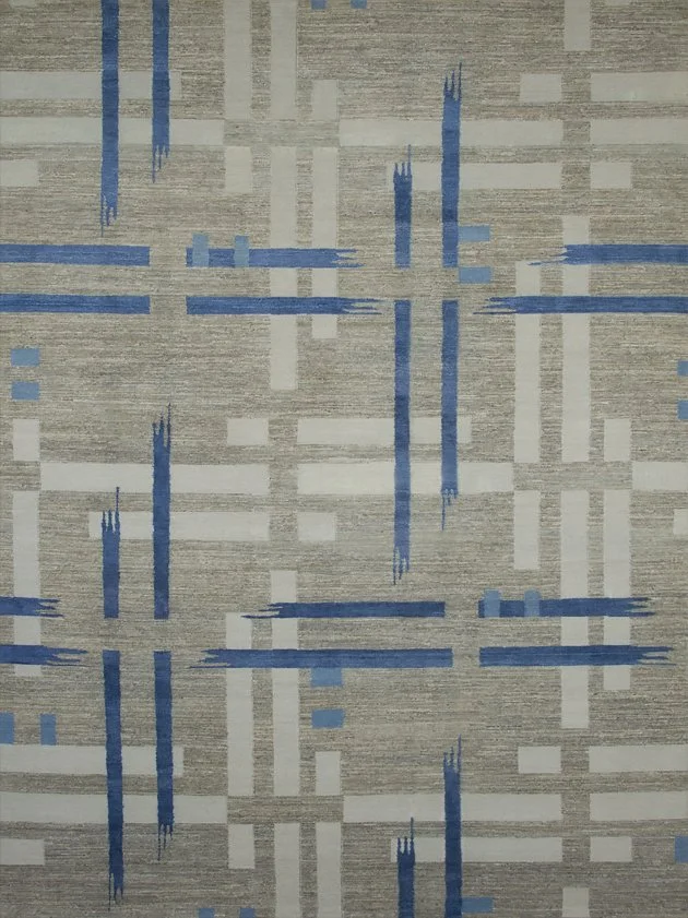 Abstract patterned carpet with intersecting blue and beige lines and blocks.