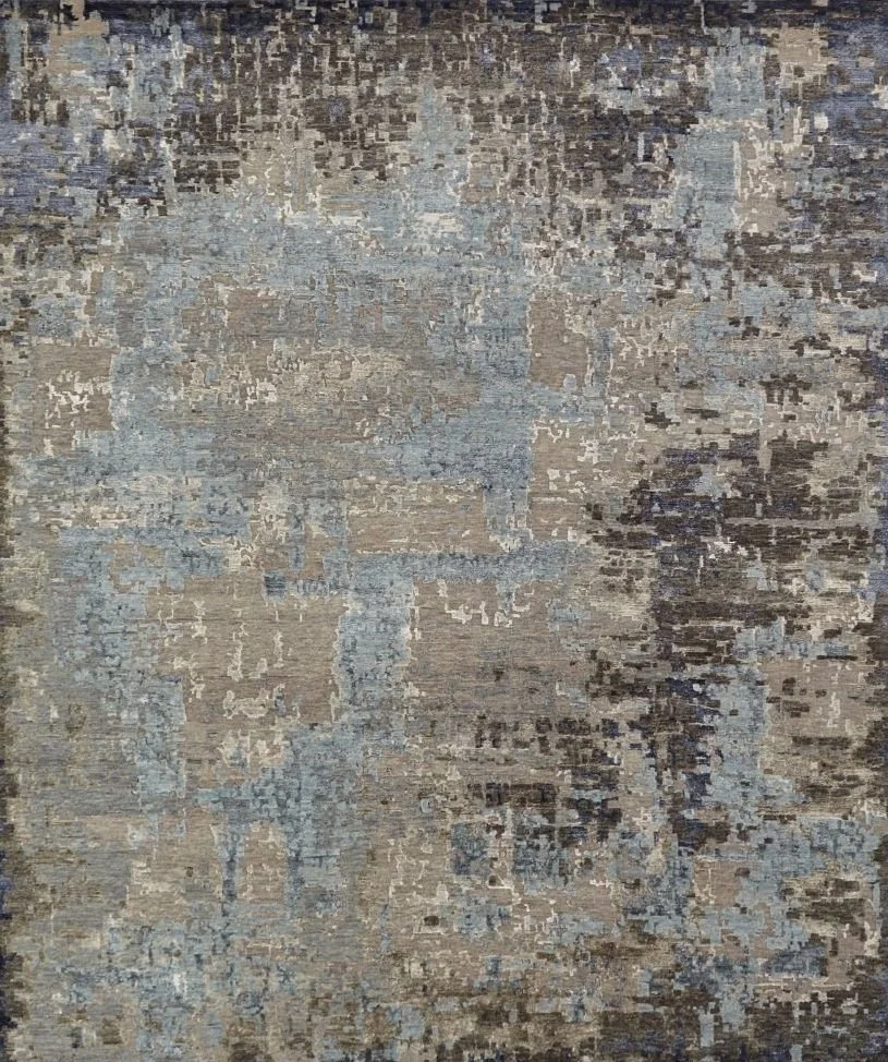 A close-up of a textured, abstract patterned rug with shades of beige, grey, and brown.
