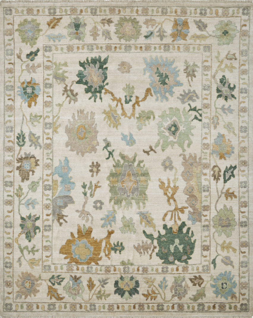 A traditional area rug with floral and vine patterns in shades of beige, green, blue, and light brown.
