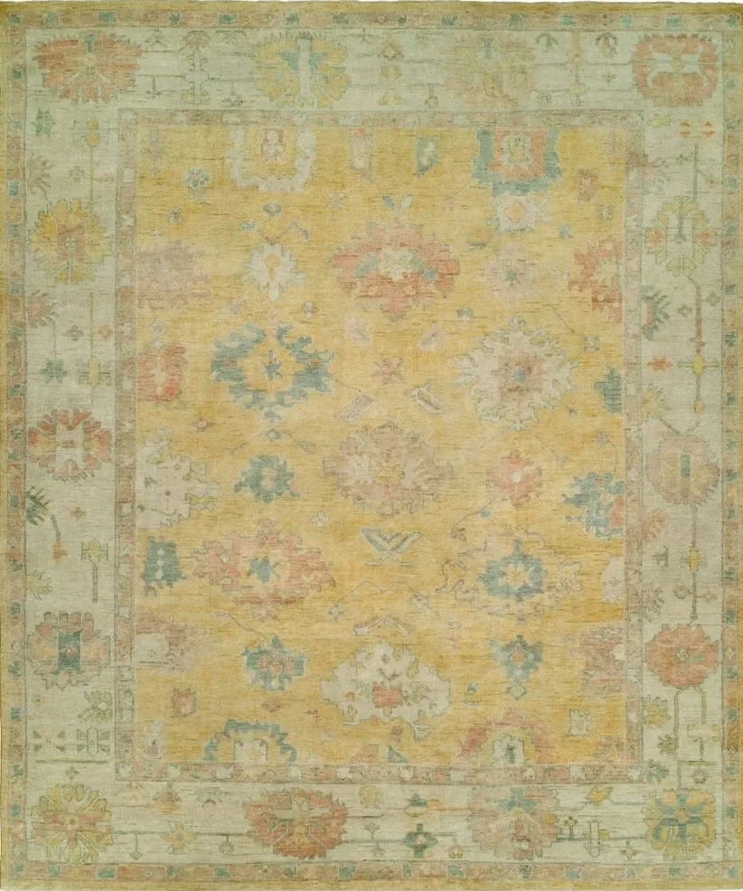A vintage-style area rug with intricate floral and geometric patterns in soft pastel colors like yellow, blue, pink, and green.