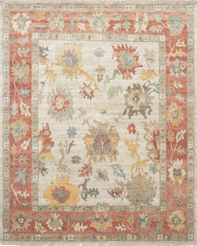 A patterned area rug with a floral and leaf design. The rug has a beige background with a red border and accents of yellow, blue, gray, and brown.