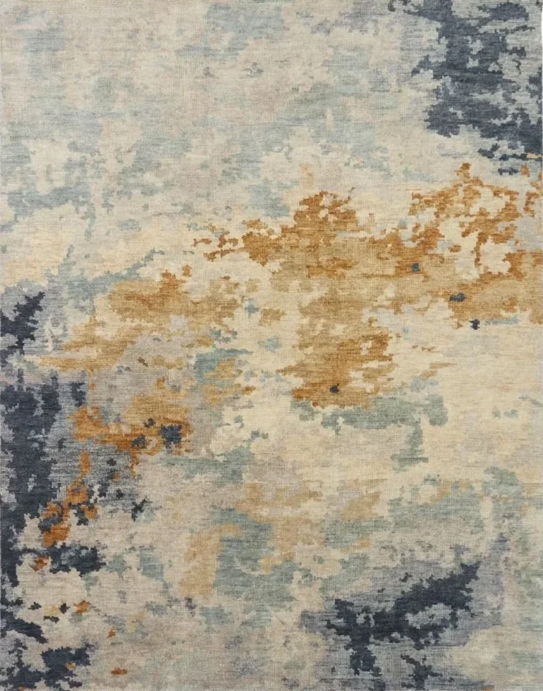 Abstract patterned area rug with shades of cream, beige, blue, and gray.