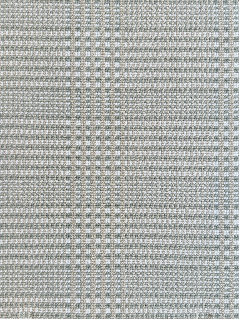 Close-up of a textured fabric with a grid pattern in shades of beige and white.