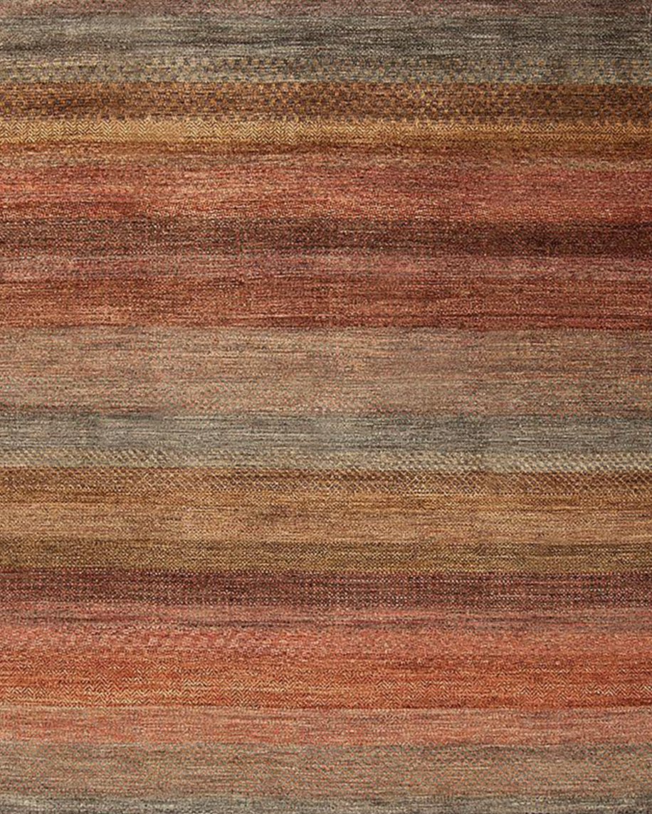 A multicolored striped woven rug with shades of brown, red, beige, and gray.