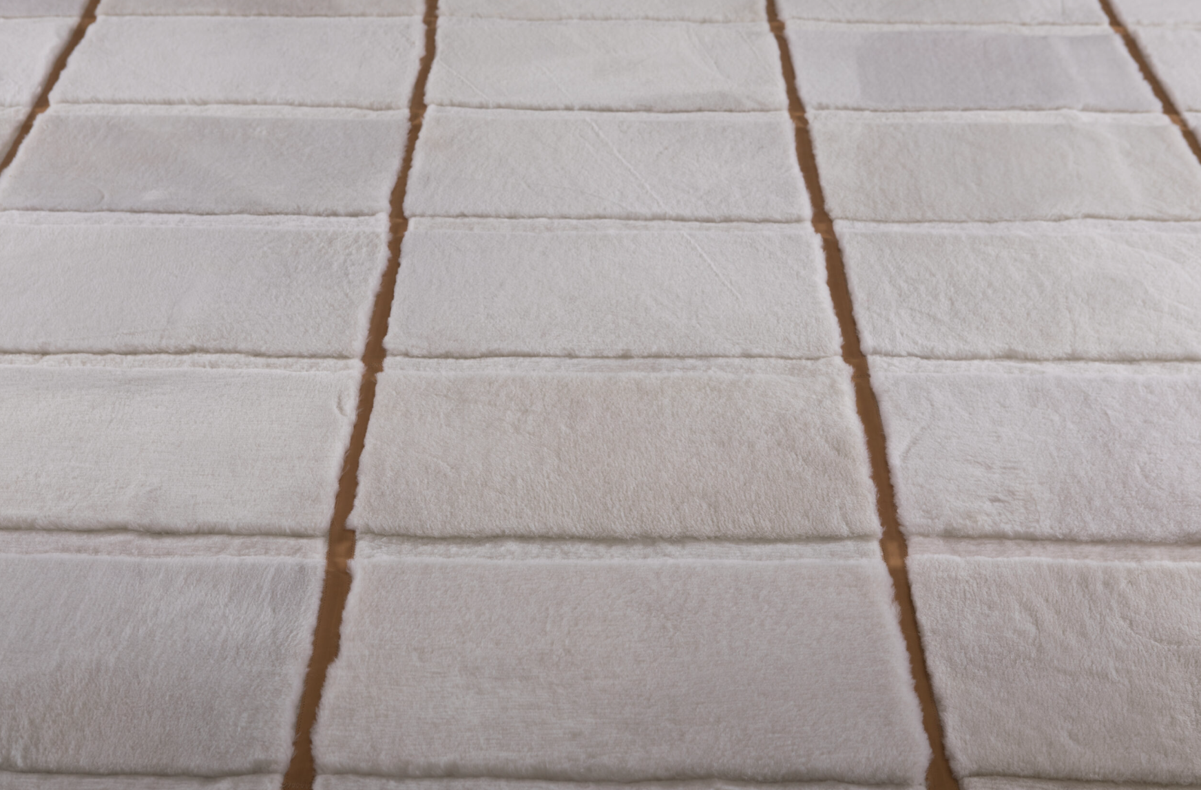 Rows of rectangular white marshmallows on a baking sheet.