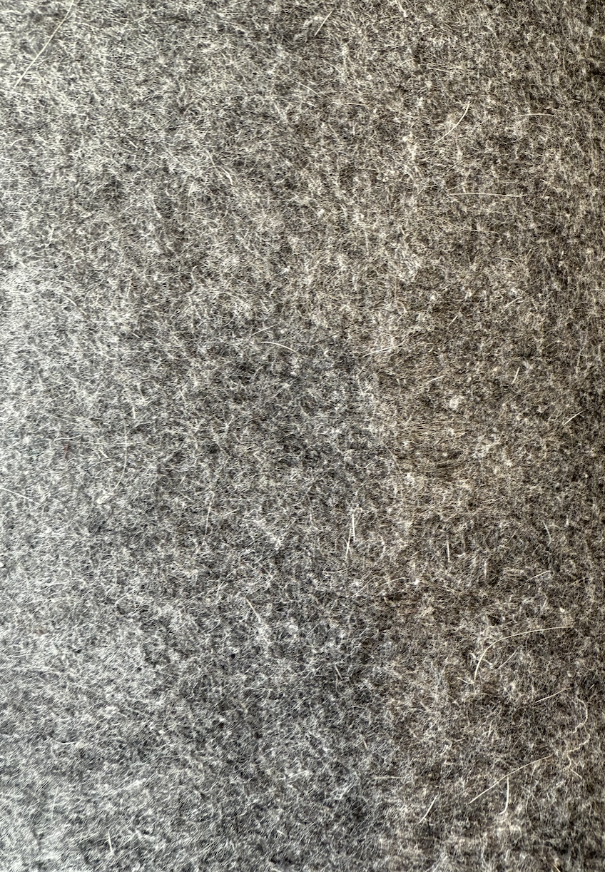 Close-up of a gray, textured fabric surface.