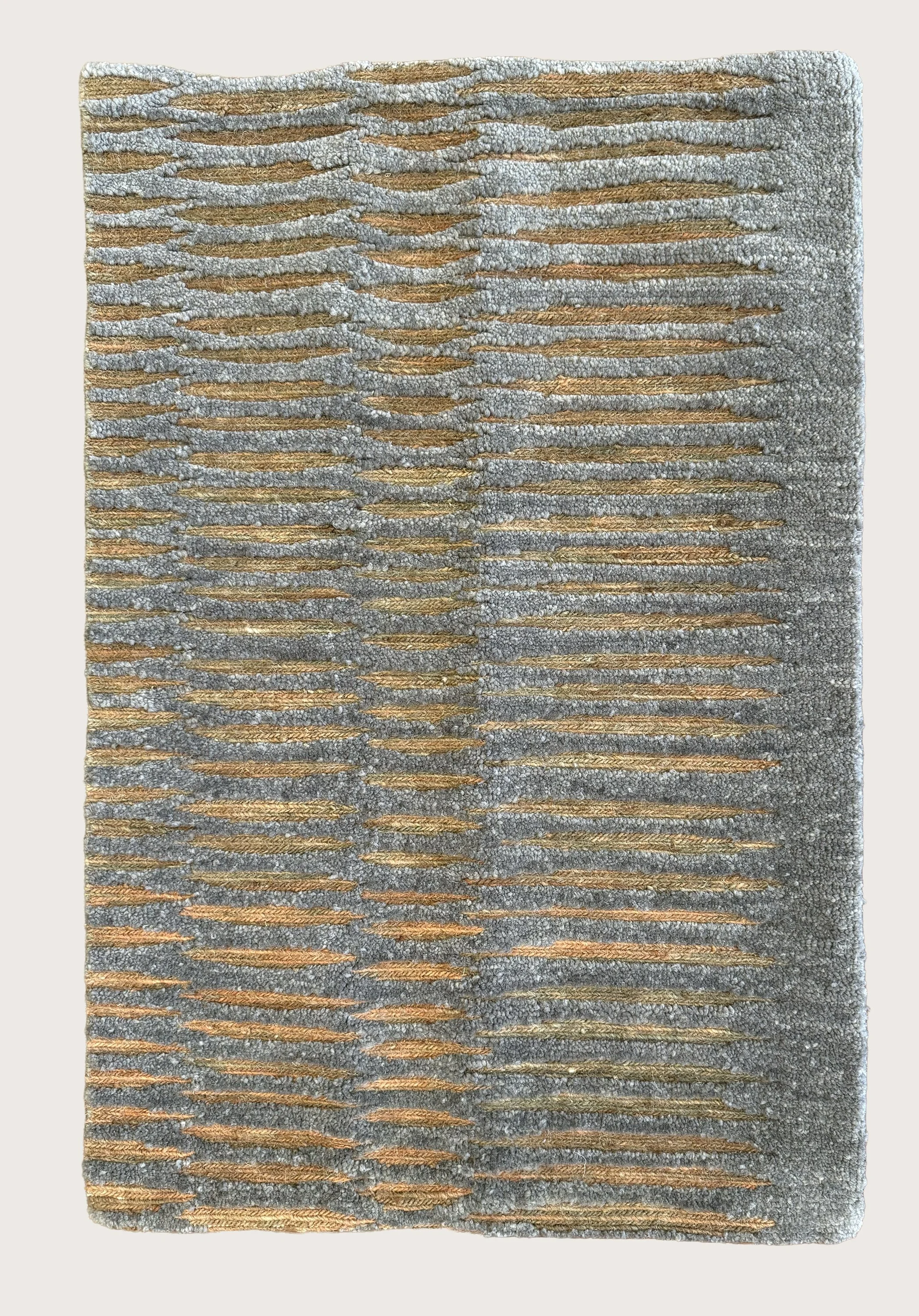 Close-up of a textured, grey rug with a amber stripes