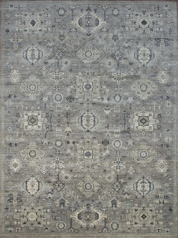 A traditional patterned area rug featuring intricate geometric and floral motifs in shades of gray, beige, and navy.