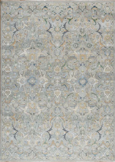 A patterned area rug with intricate floral and geometric designs in shades of blue, beige, gray, and gold.