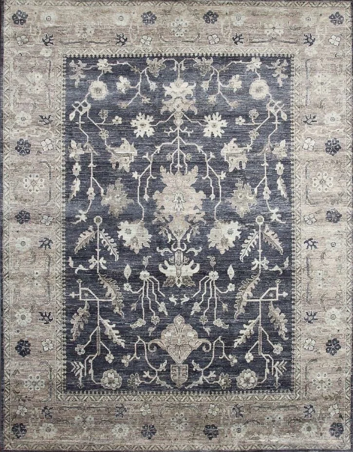 A traditional rectangular area rug with intricate floral and vine patterns in navy blue, beige, and cream colors.