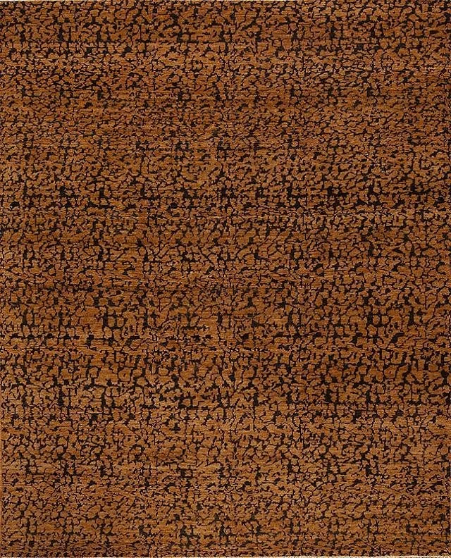 Close-up of a textured surface with a brown and black cracked pattern, resembling dry, cracked earth or a painted surface.