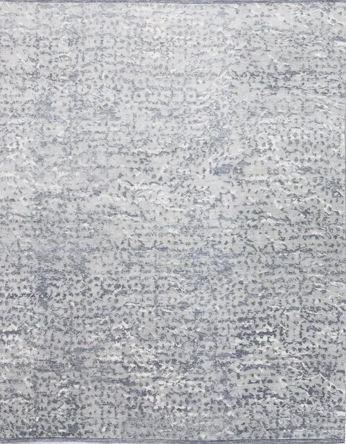 Close-up of a gray and white textured carpet with a subtle pattern.