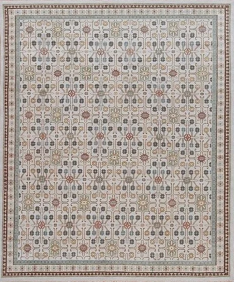 A decorative area rug with a geometric pattern in shades of beige, gray, and red, featuring floral motifs and bordered with a detailed frame.