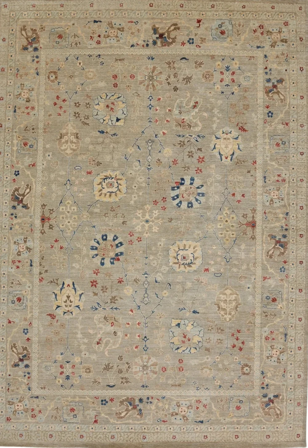 A traditional beige, cream, and red rug with intricate floral and animal patterns. The design features stylized flowers, leaves, and small animal motifs arranged symmetrically across the surface, with a detailed border.