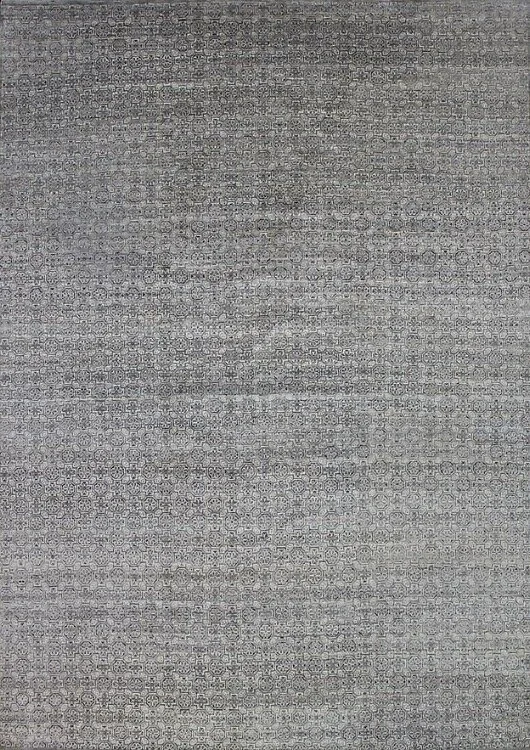 A close-up of a textured gray fabric surface with a faint pattern of small circles.
