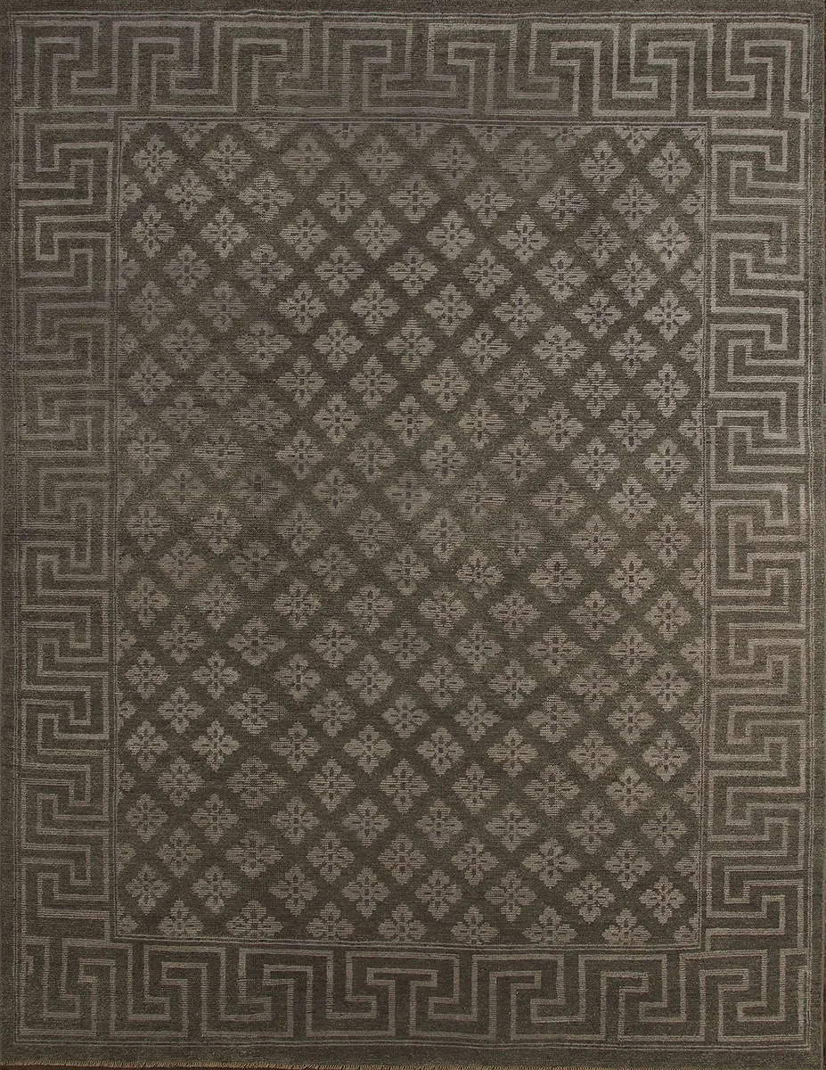 A decorative area rug with a geometric pattern and a border featuring Greek key motifs.