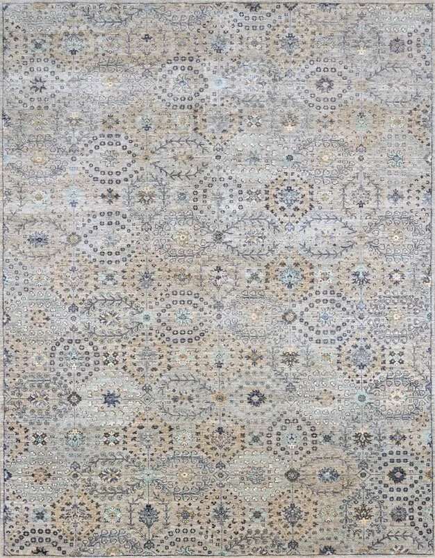 A light-colored patterned area rug with intricate geometric and floral designs in shades of beige, cream, blue, and gray.