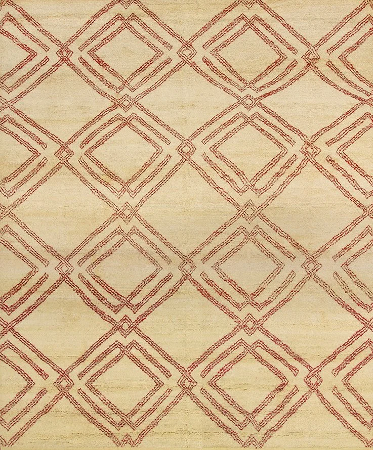A beige rug with a red geometric diamond and square pattern.