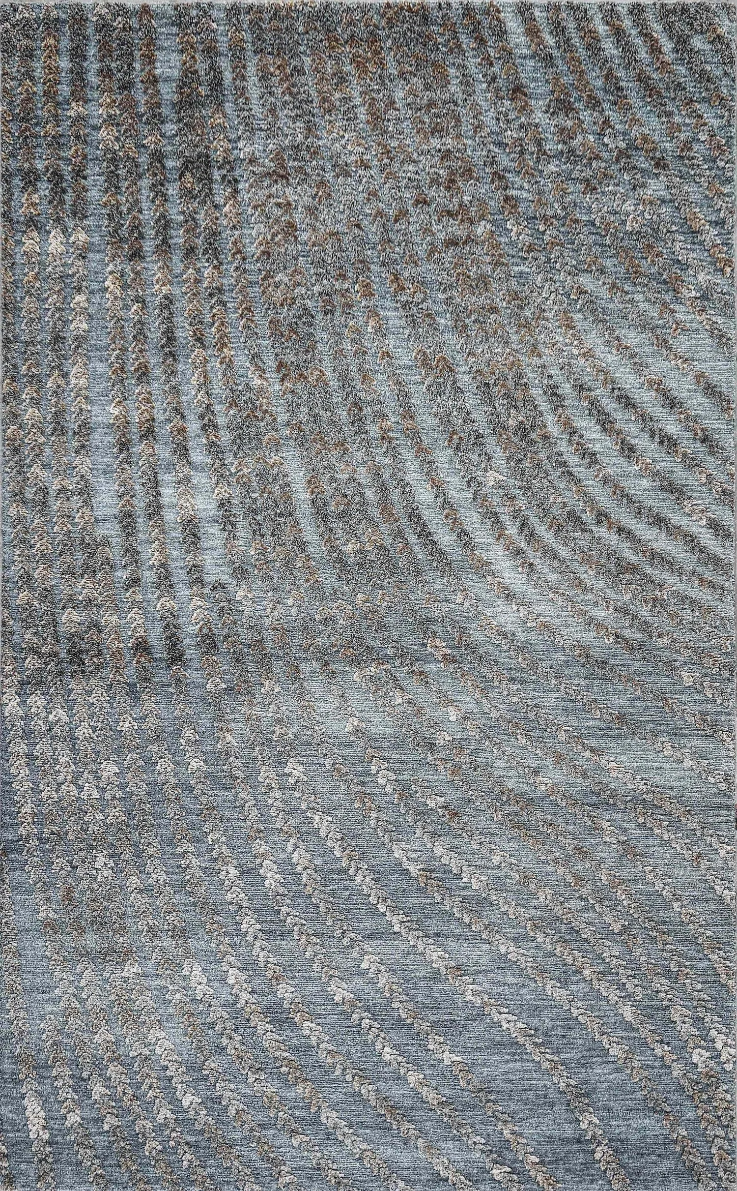 A patterned carpet with swirling and striped designs in shades of blue, gray, and brown.