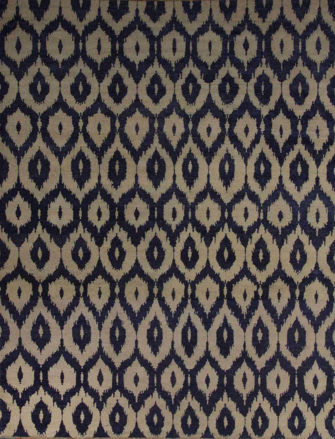 Patterned fabric with a repeating geometric design in black and beige.
