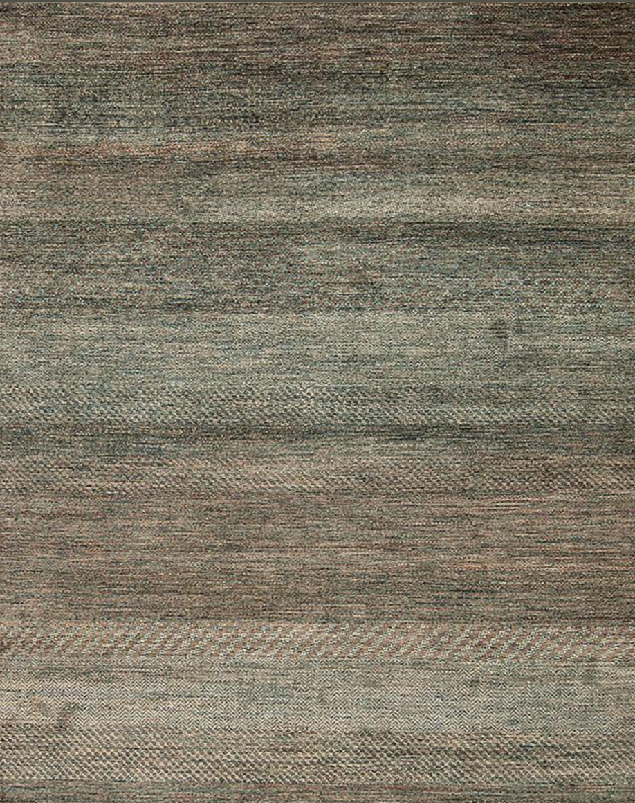 Close-up of a textured, multicolored woven fabric or rug with horizontal stripes in shades of gray, beige, and brown.