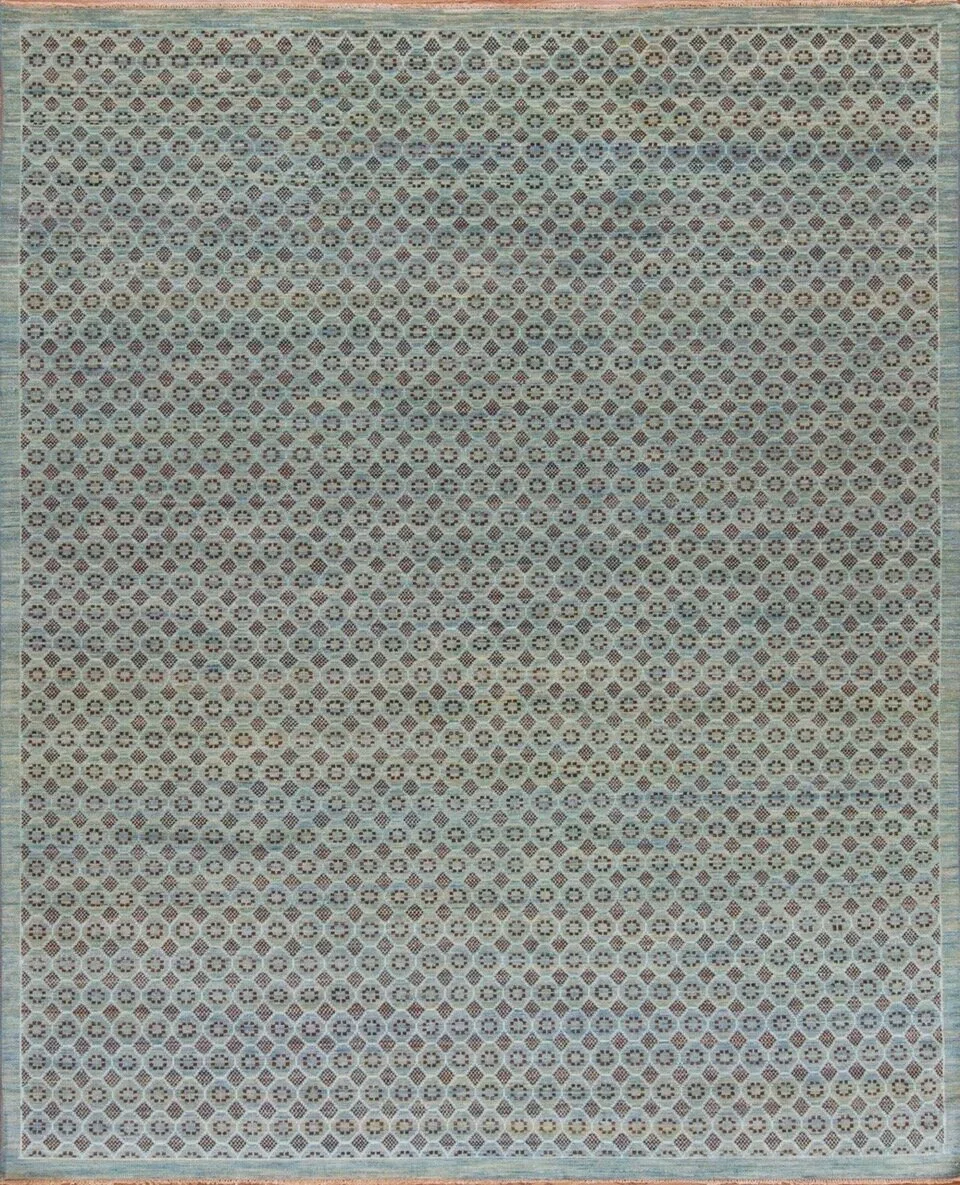 A large patterned area rug with geometric designs in beige, red, and dark blue colors, covering entire floor space.